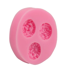 Close-up of 3-cavity pink silicone mold with detailed daisy floral texture for DIY baking