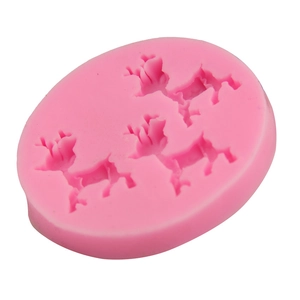 Close-up of pink silicone mold with three reindeer patterns for cake and chocolate decorating