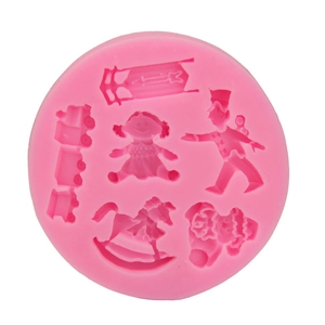 Pink silicone mold featuring carousel horse and vintage toy shapes for cake decorating
