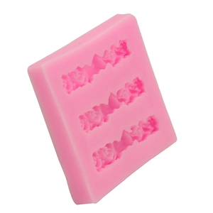 Detailed macro of pink silicone mold featuring three rows of embossed roses for baking