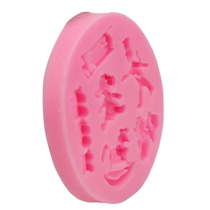Detailed macro view of pink silicone mold with cartoon character cavities for DIY baking