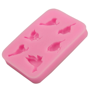 Close-up of pink silicone bird mold showing five different detailed bird shapes for baking