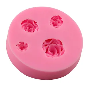 Pink silicone mold featuring four various sized rose flower shapes for DIY cake decorating
