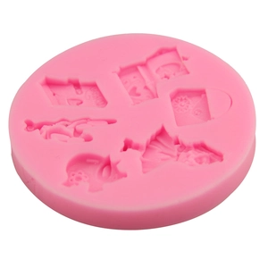 Pink silicone round mold featuring small pig and book shapes for DIY fondant baking