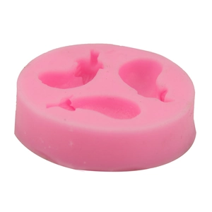 Macro view of a pink silicone mold with three vegetable cavities for DIY baking and crafting