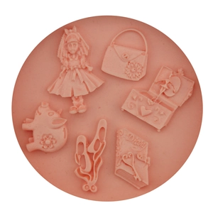 Pink silicone mold featuring girl doll, handbag, and pig shapes for DIY cake baking