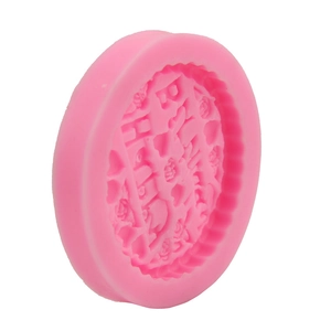 Detail of pink silicone mold featuring Happy Birthday text with roses and hearts