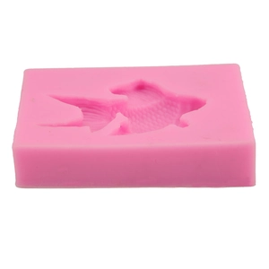 Detailed macro view showing the fine goldfish scale textures inside the pink silicone mold