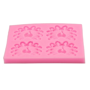 Detailed macro view of 4-cavity pink silicone peacock mold for fondant and chocolate cake