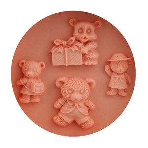 Pink silicone mold featuring four distinct cartoon bear shapes for DIY baking and soap making