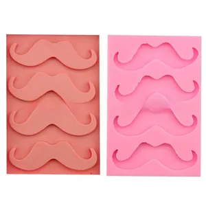 Detail view of pink mustache-shaped silicone molds for fondant baking and DIY chocolate crafting