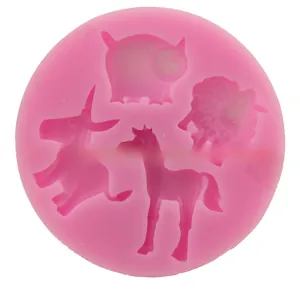Close-up of pink silicone mold with pig, sheep, donkey and horse shaped cavities