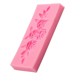 Pink silicone mold featuring detailed rose and leaf designs for fondant cake decorating