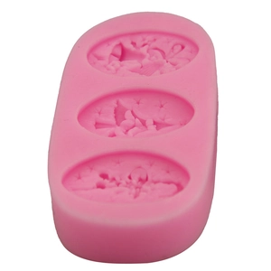 Pink silicone fondant mold featuring three oval cavities with star, moon and wave patterns