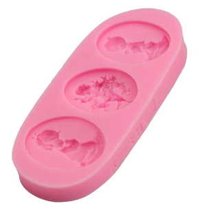 Pink silicone mold with 3 round cavities featuring floral patterns for fondant and soap