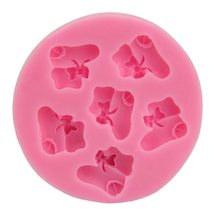 Pink silicone mold featuring five baby bootie shapes with bows for DIY baking and crafts