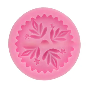 Macro detail of leaf and star textures inside a round pink silicone fondant mold