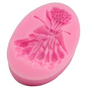 Pink silicone fondant mold featuring a ruffled dress design for DIY baking decoration