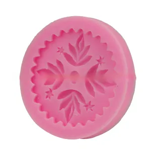 Detailed macro view of a pink round silicone mold featuring intricate floral leaf patterns