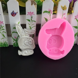 Pink silicone DIY rabbit mold with finished silver-colored bunny shape for cake baking