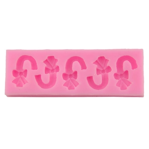 Pink silicone Christmas candy cane mold with bow designs for DIY baking and chocolate making
