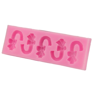 Pink silicone candy cane mold with bow details for DIY Christmas baking and chocolate