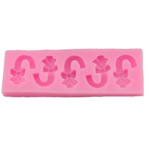 Pink silicone mold featuring five candy cane shapes with bows for DIY baking and crafts