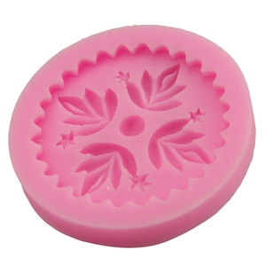 Pink silicone cake mold with leaf and star patterns for DIY baking and fondant crafts