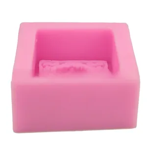 Detail of pink silicone square mold with 3D embossed sunflower pattern for DIY baking