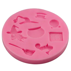 Pink silicone Halloween baking mold featuring wizard hat, broom, and magic book shapes