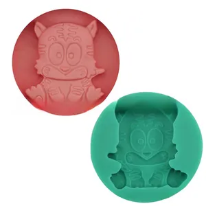 Detail showing two cartoon tiger silicone molds in pink and green for baking