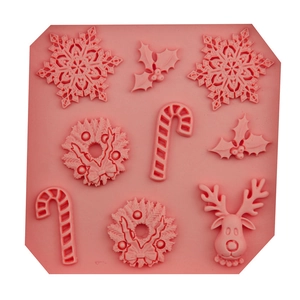 Pink Christmas silicone mold with snowflakes, reindeer, and candy cane for DIY baking