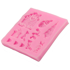Pink silicone Christmas mold for baking gingerbread houses, trees, and gift boxes