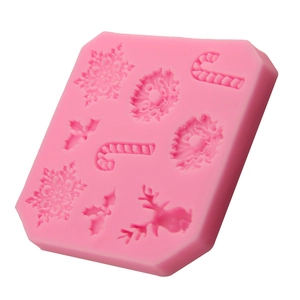 Pink silicone Christmas fondant mold with snowflake, reindeer, and candy cane shapes
