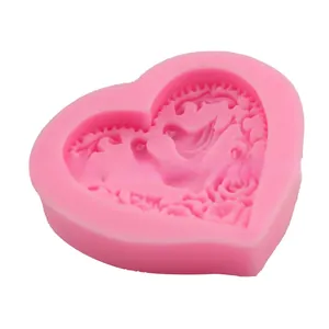 Macro detail of pink heart silicone mold with intricate floral relief patterns for DIY crafts
