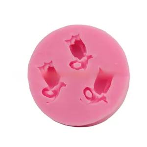 Detail of pink silicone mold with three bird shapes for DIY cake and chocolate decoration