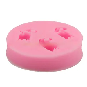 Close-up of pink round silicone mold with three star-shaped cavities for DIY baking