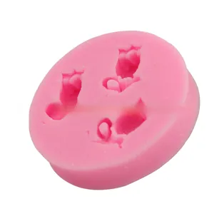 Detail view of pink silicone mold with 3 tulip flower cavities for fondant cake baking