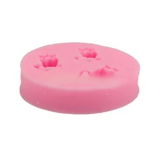 Close-up of pink silicone mold with three detailed tulip flower cavities for DIY baking