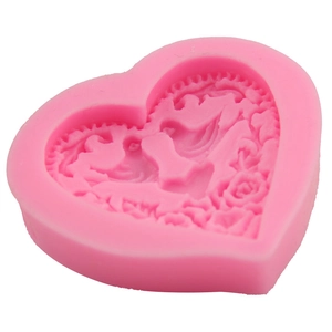 Pink heart-shaped silicone mold with detailed floral embossed patterns for DIY baking