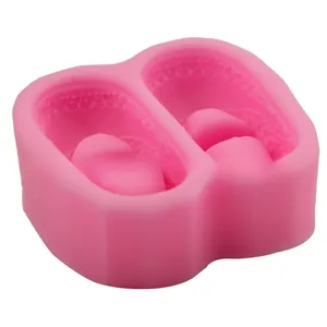 Dettaglio dello stampo in silicone rosa per scarpe da neonato con due cavità per fondant