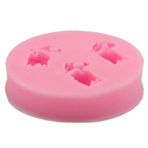 Pink silicone mold featuring three cartoon dinosaur shapes for DIY cake decorating