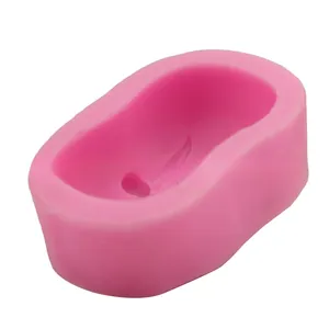 Close-up of pink silicone olive leaf mold showing detailed feather wing relief patterns