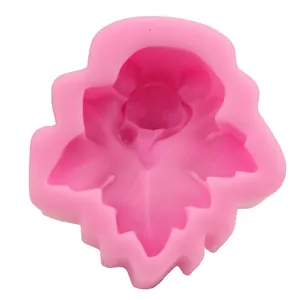 Detail of leaf-shaped pink silicone mold with animal face for DIY fondant and baking