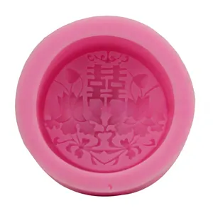 Detail of pink silicone cake mold with embossed double happiness flower pattern