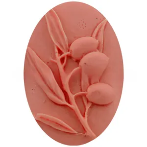 Close-up of pink silicone mold with embossed olive leaf and fruit relief pattern