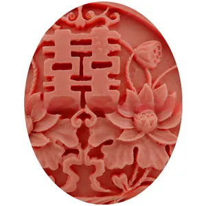 Macro shot of 3D traditional Chinese Xi character with lotus patterns on red fondant mold