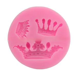 Detailed macro view of pink silicone mold with three ornate 3D crown designs for baking