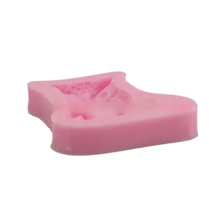 Detailed pink silicone owl mold showing intricate 3D interior relief patterns for baking