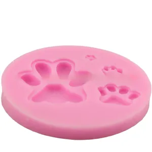 Close-up of pink silicone mold featuring dog paw and star patterns for DIY baking